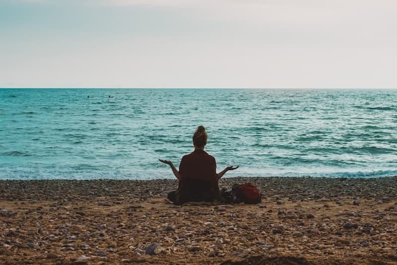Woman meditating by the sea
